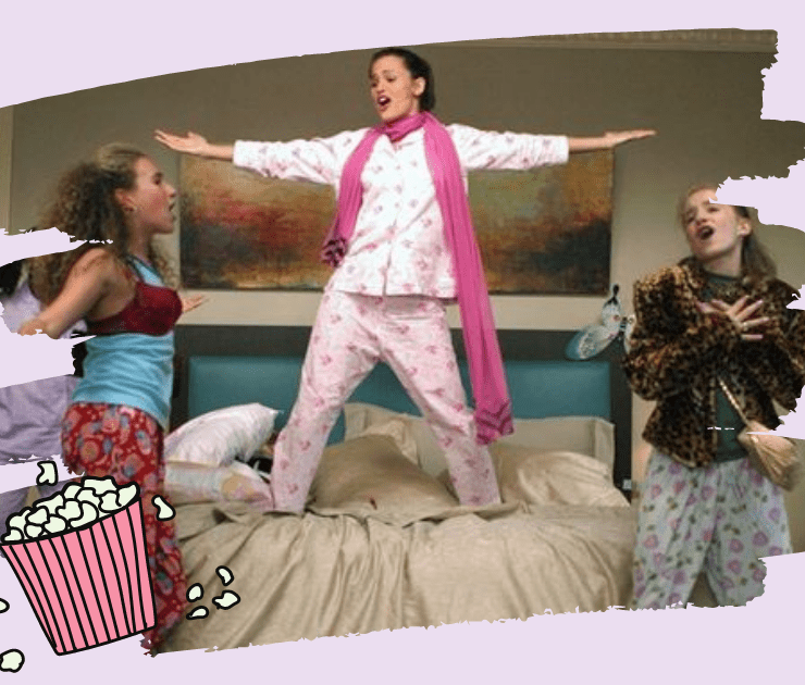 a picture to accompney an article titled "30 Brilliant Movies To Watch At Your Next Sleepover". It's shows a scene from the movie 13 Going On 30. 3 women sing on the bed at a sleepover